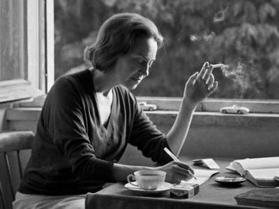Sophia de Mello writing and smoking by the window